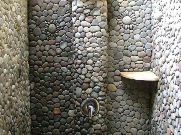 Pebble-stone open-air shower in a Beach Cottage