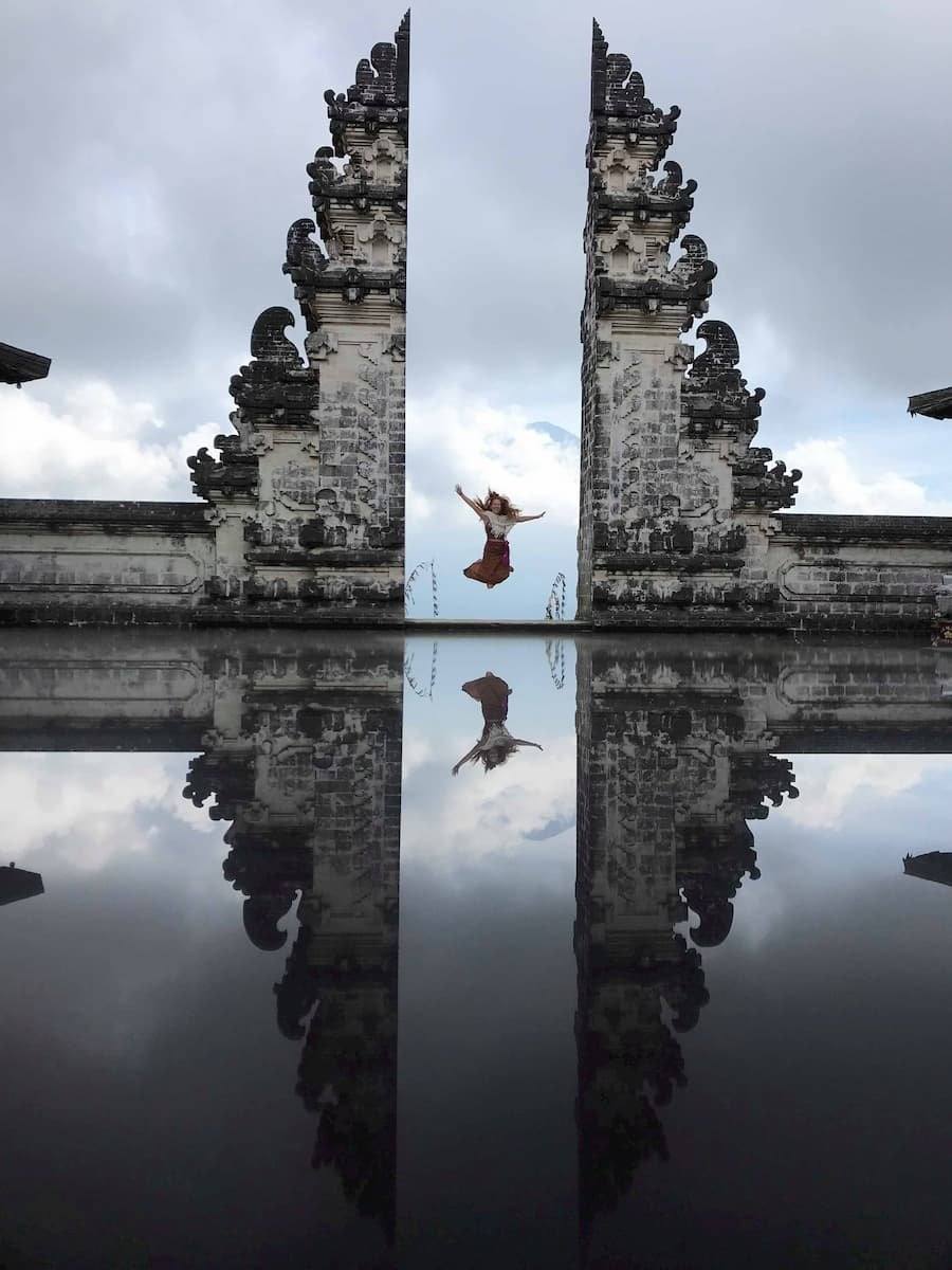 The Gates of Heaven split gate at Pura Lempuyang temple, reflected in the courtyard