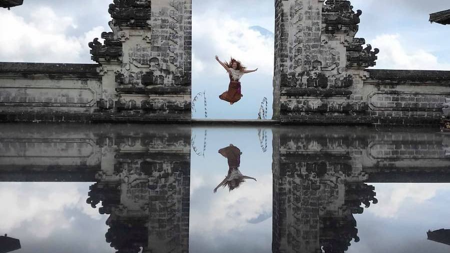 The Gates of Heaven split gate at Pura Lempuyang temple, reflected in the courtyard