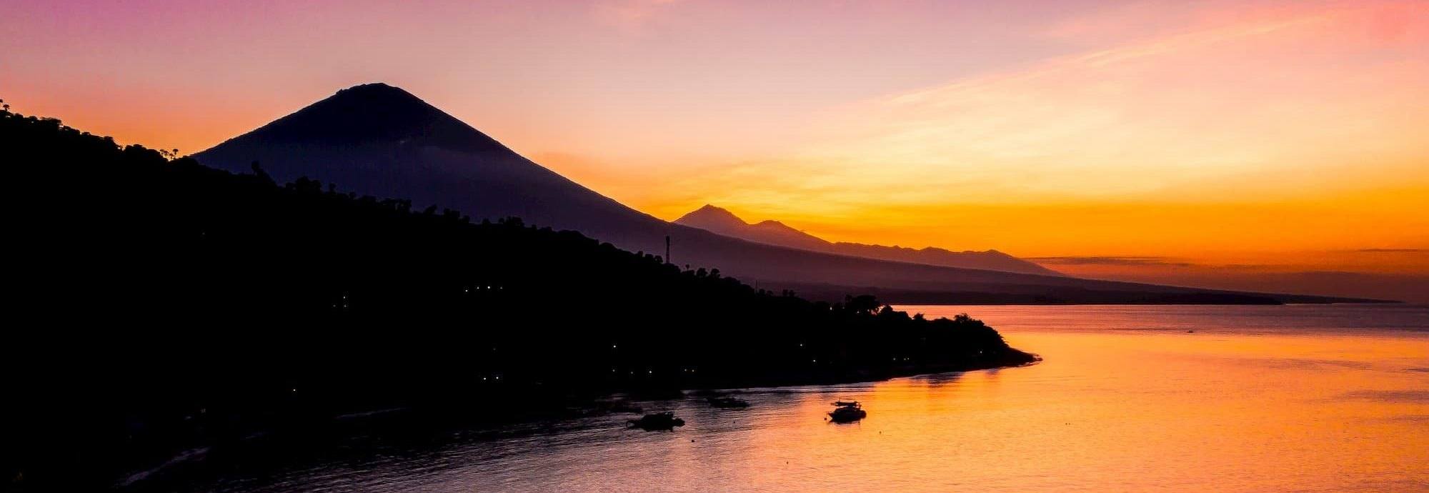 Mount Agung silhouetted at sunset above the east Bali coast