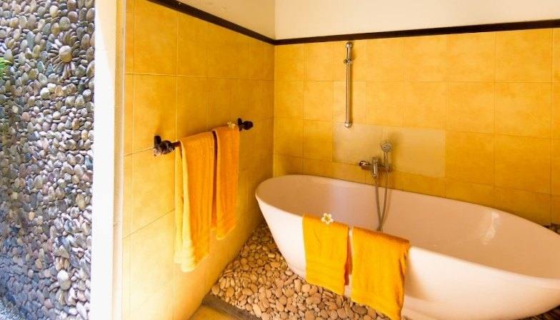 Freestanding bathtub in the stone bathing area of Paradiso Villa