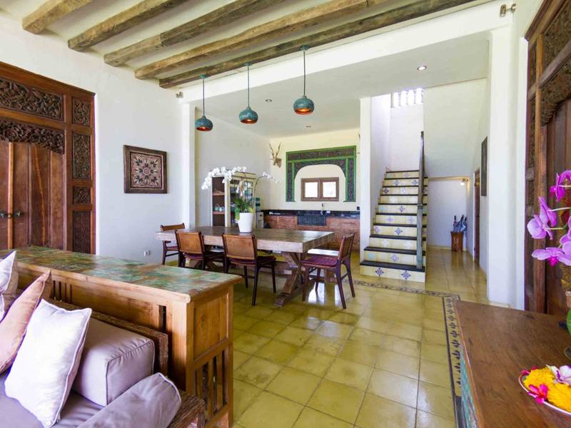 Dining room of the Perfumed Garden with wooden table and staircase
