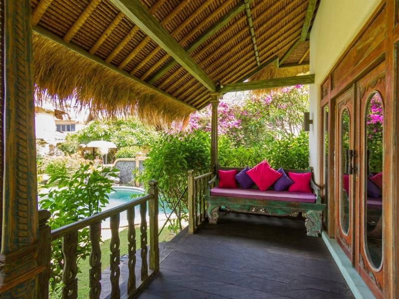 Veranda with cushions and bougainvillea outside a Perfumed Garden bedroom