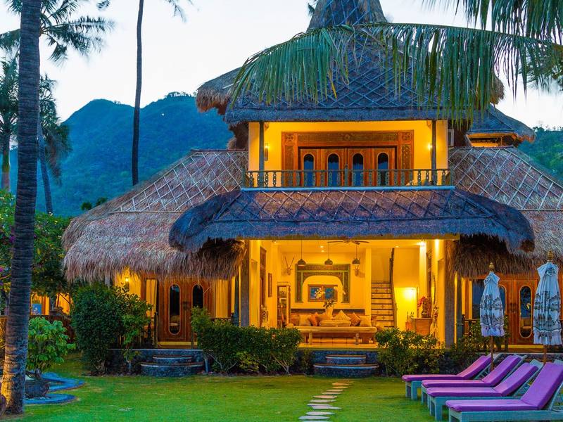 The Perfumed Garden villa lit up at dusk with Mount Agung behind