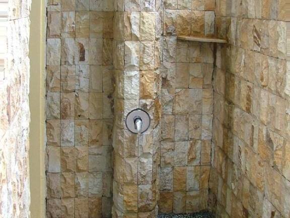 Natural-stone open-air shower in Sari Sunrise Villa