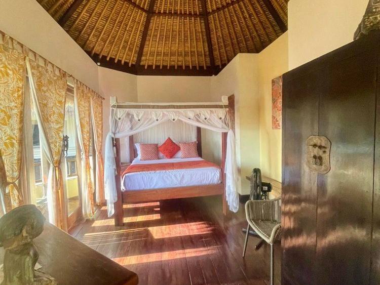 Wide view of the upper bedroom of Sari Sunrise Villa under the thatched roof