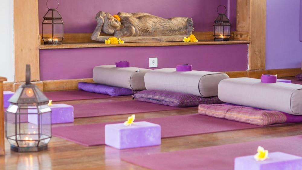 The shala altar with a reclining Buddha, bolsters and blocks