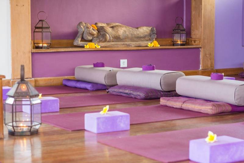 The shala altar with a reclining Buddha, bolsters and blocks
