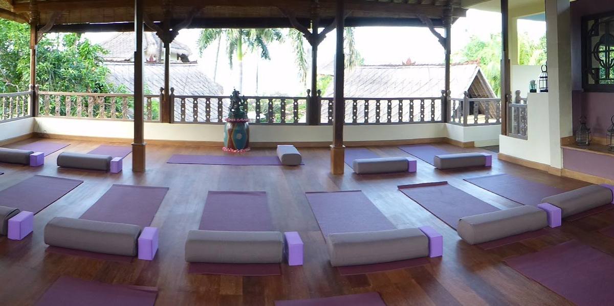 Panorama of the yoga shala with mats, bolsters and blocks laid out