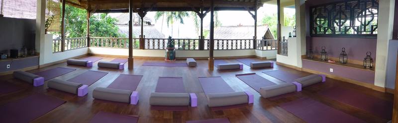Panorama of the yoga shala with mats, bolsters and blocks laid out